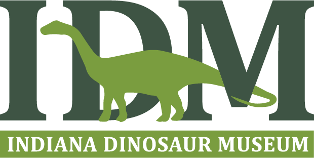 Image that reads "IDM Indiana Dinosaur Museum" with a green dinosaur behind the text